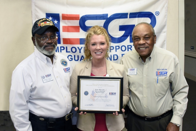 Kate Miccichi, McLeod's Director of Patient Relations, holding an award given to her by the Employer Support of the Guard and Reserve organization