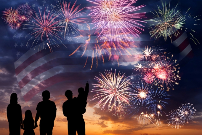 An illustration of fireworks with a family in silhouette in front