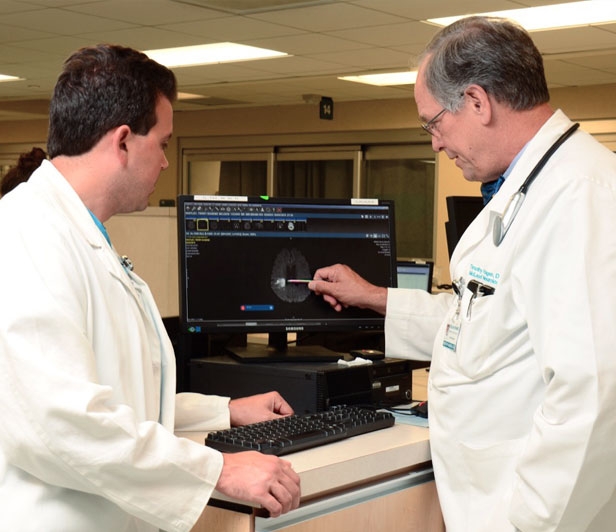 Two McLeod doctors working together to review a patient's CT scan