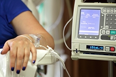 A woman's arm hooked up to a chemotherapy infusion pump