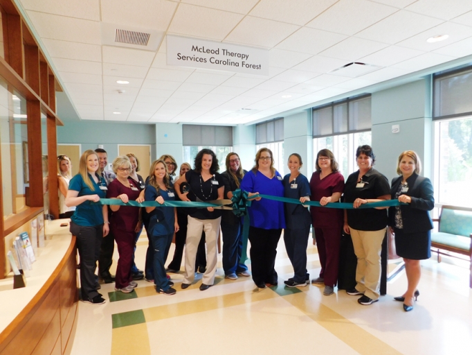 Staff and administrators cutting the ribbon for the McLeod Pediatric Rehabilitation office in Carolina Forest