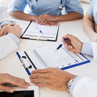 A group of doctors going over a patient chart together