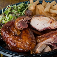 A plate of Southern food including fried turkey and french fries