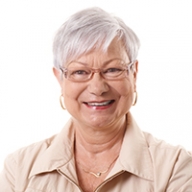 A smiling older woman with white hair